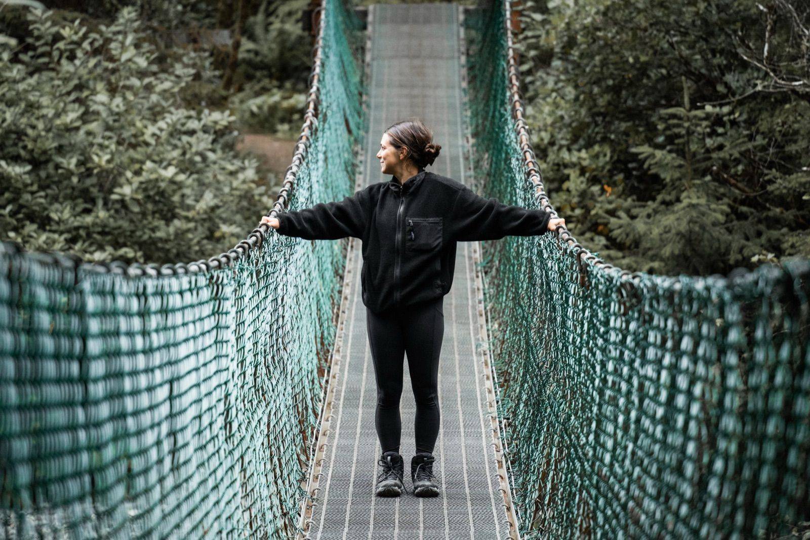 Andi Cross on a suspension bridge during expedition in Victoria, Canada