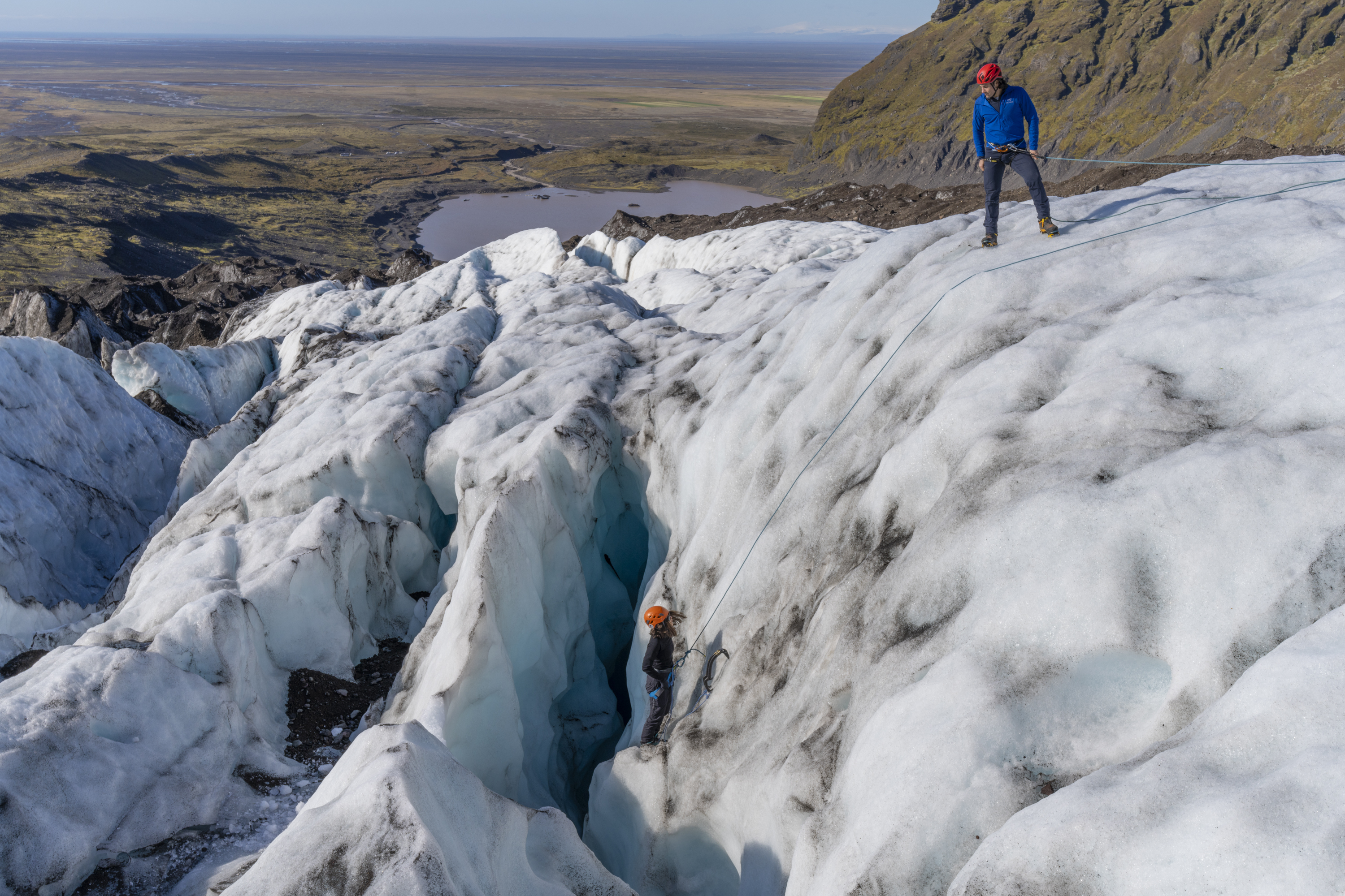 Andi Cross glacier climbing expedition, navigating ice crevasse with climbing gear
