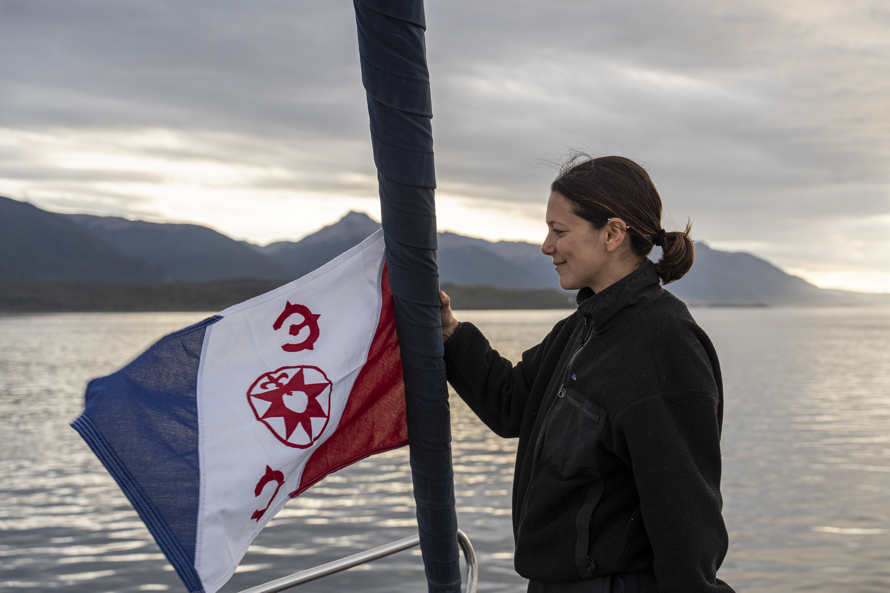 Andi Cross holding the Explorers Club flag, Peninsula Mitre