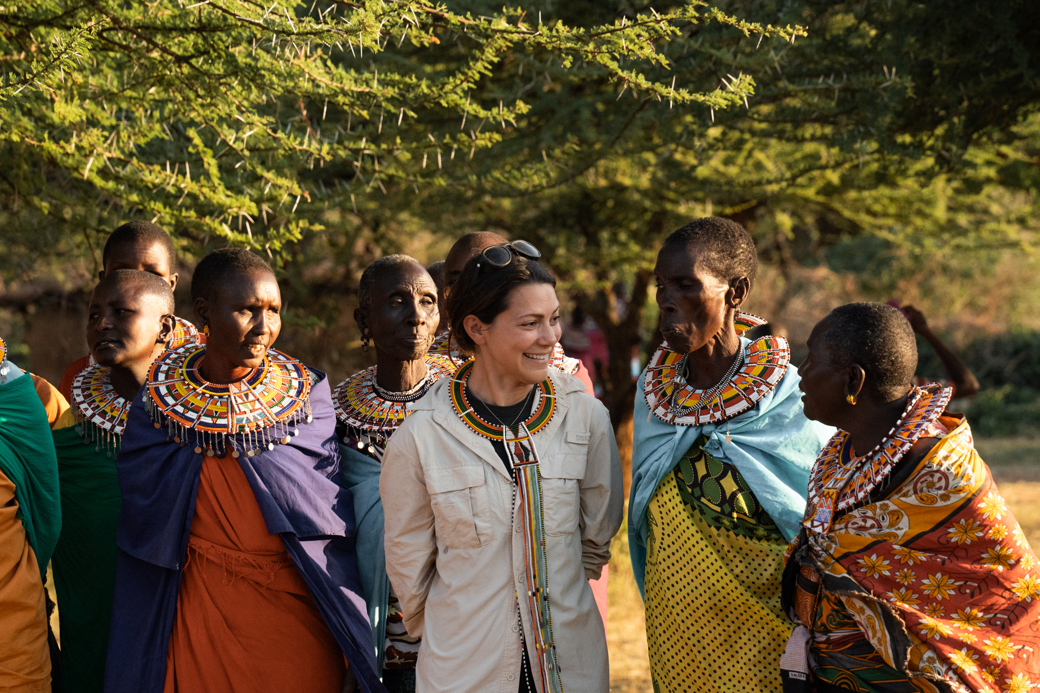 Andi Cross with Masai women in traditional beaded jewelry at Loisaba Conservancy, Kenya, celebrating community partnership